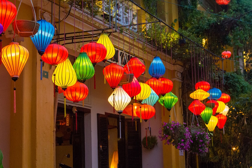 Silk lanterns are hanging in front of boutique shops' doors