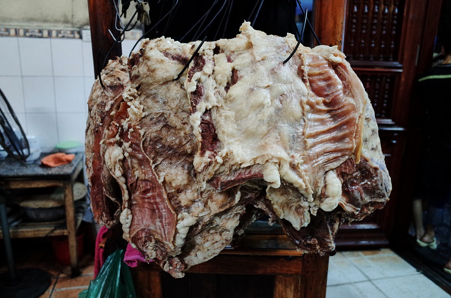 Huge cuts of boiled beef are hanging on the hooks, waiting to be served
